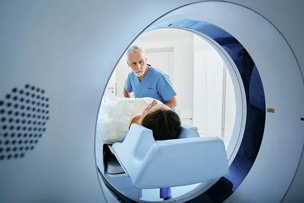 Patient having CT scan with clinician