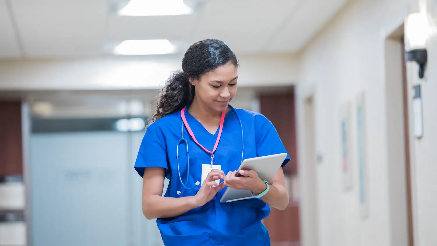 Young adult nurse working on digital tablet