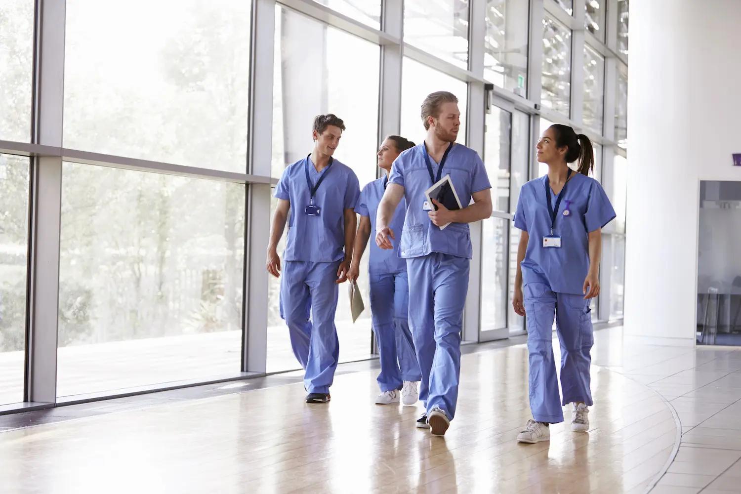 Clinicians walking along corridor