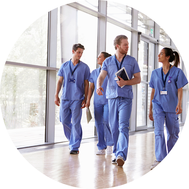 Clinicians walking and talking along corridor