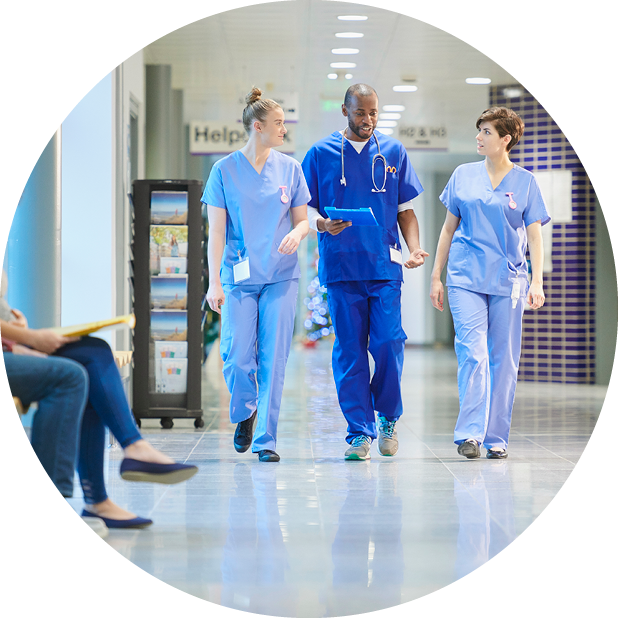 Clinicians walking and talking along corridor