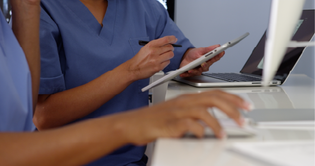 Close up of two female doctors working with devices