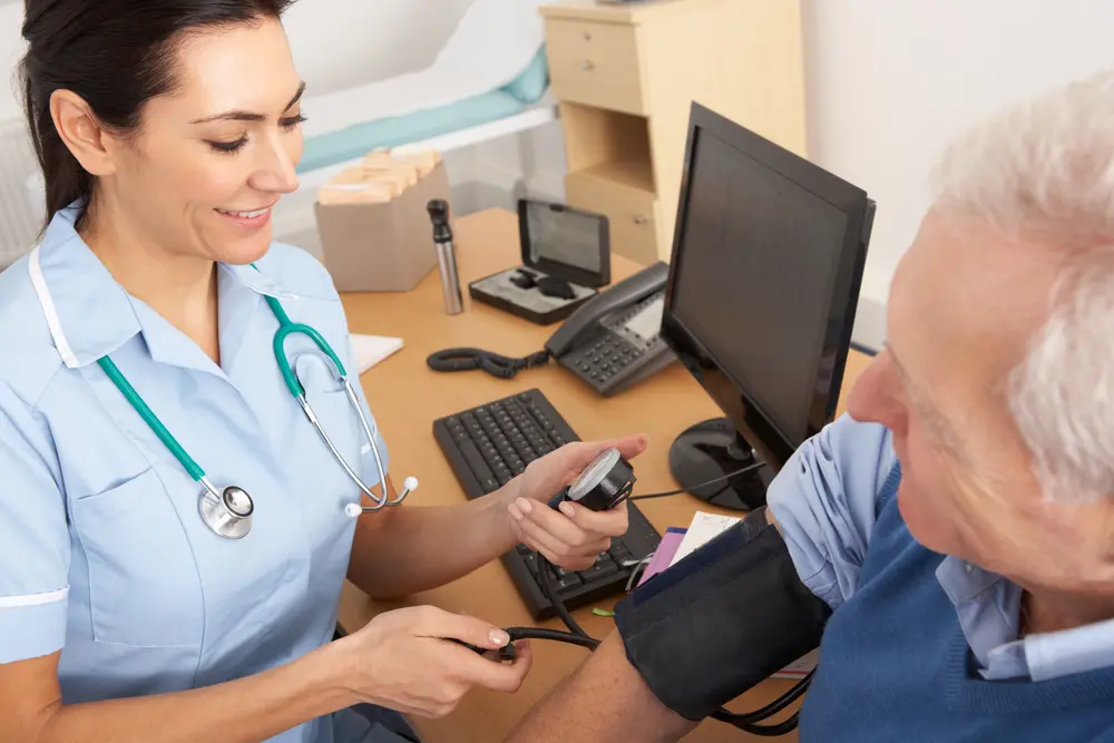Nurse taking man's blood pressure