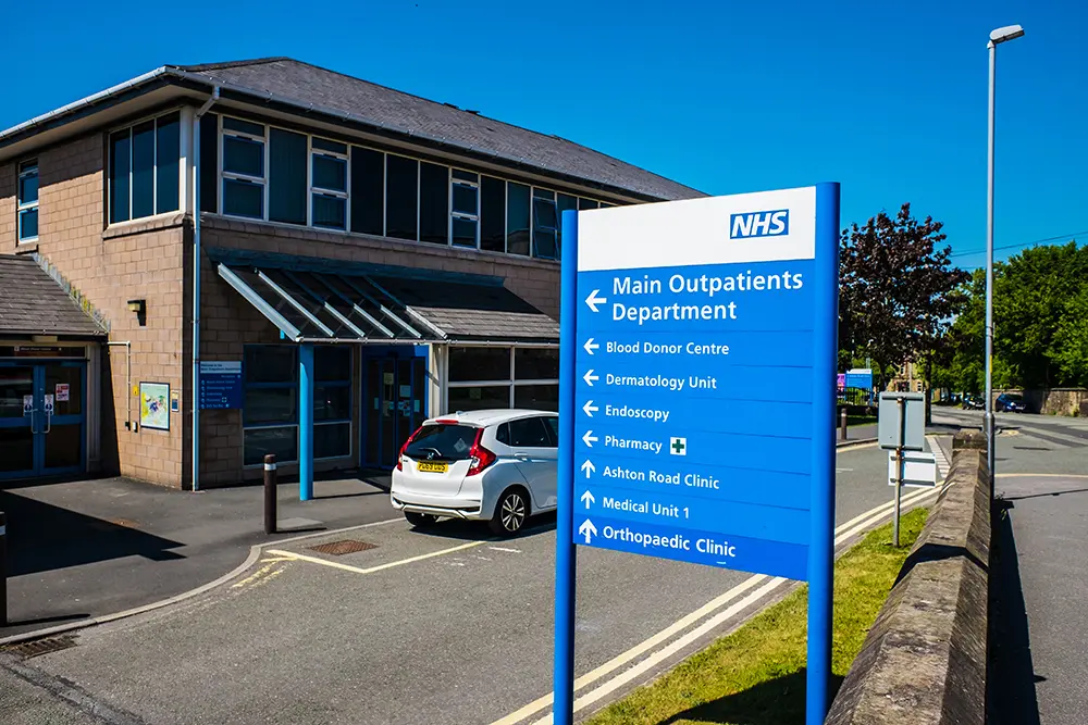 Outpatient department sign outside NHS hospital