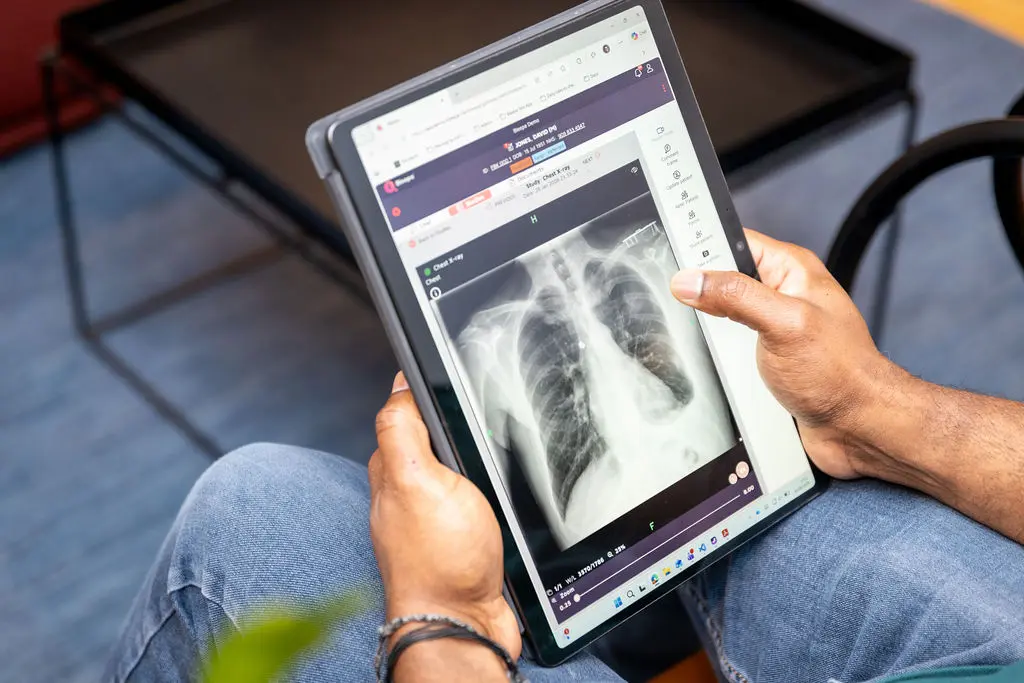 A clinician reviews an x-ray image on a tablet via the Bleepa platform.
